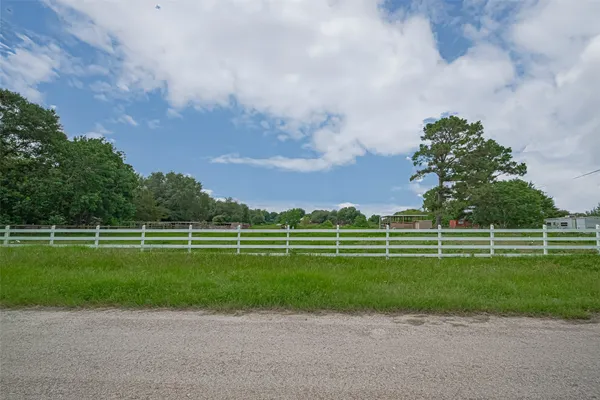 a view of a green field with lots of trees