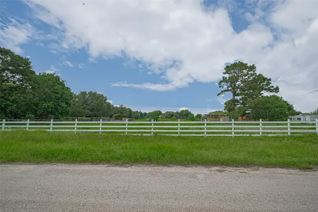 a view of a green field with lots of trees