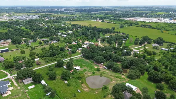 a view of a city with lush green forest