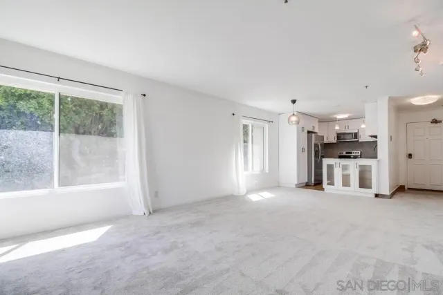 a view of a livingroom with an empty space and a fireplace