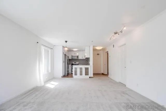 an empty room with furniture and a fireplace