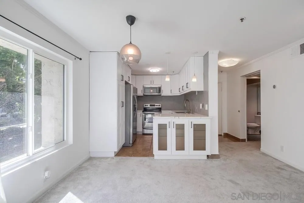 5645 Friars Road, Unit 363 San Diego, CA 92110 - Photo 10 of 74 a view of a kitchen with stainless steel appliances kitchen island a large window and a sink