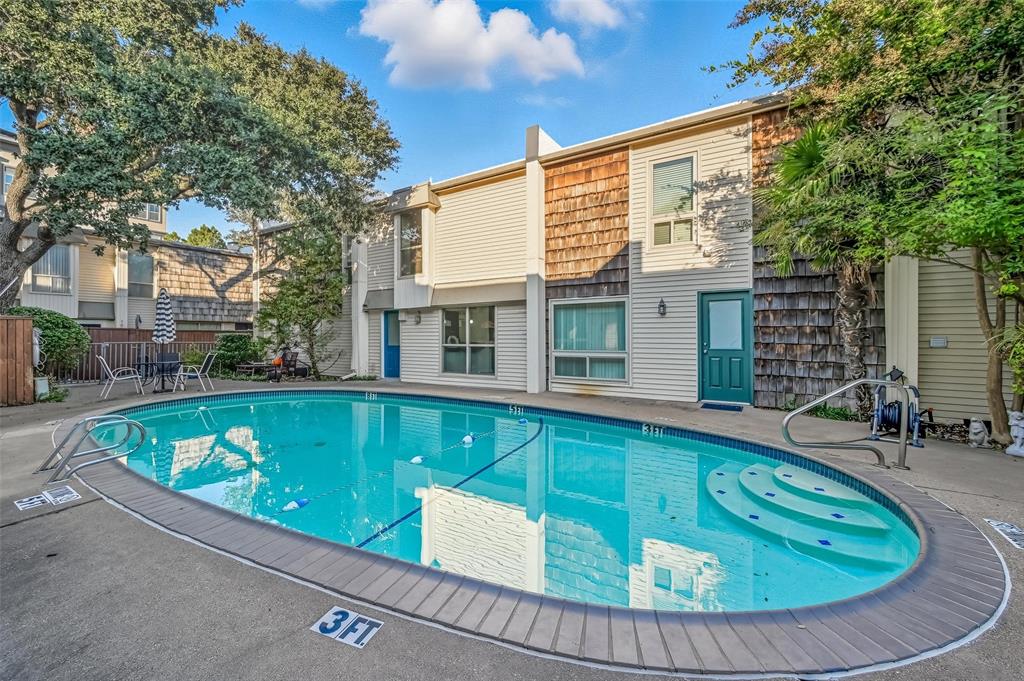 2702 Douglas Avenue, Unit 121 Dallas, TX 75219 - Photo 32 of 34 a view of a house with swimming pool