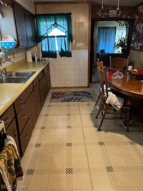 457 Spaulding Street Akron, OH 44310 - Photo 7 of 10 Kitchen with light tile floors, sink, and dark brown cabinets