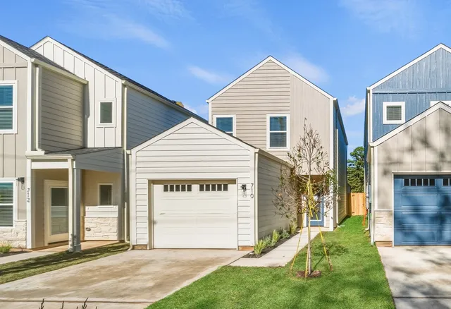 a view of a house with a yard and garage