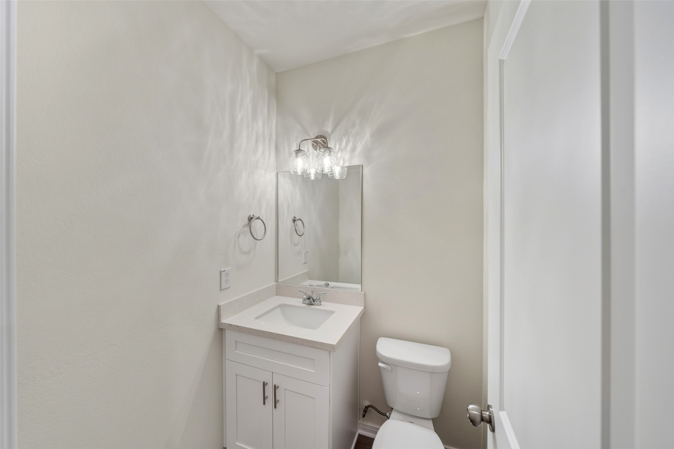 710 West Dallas Street Conroe, TX 77301 - Photo 12 of 19 a bathroom with a toilet sink and mirror
