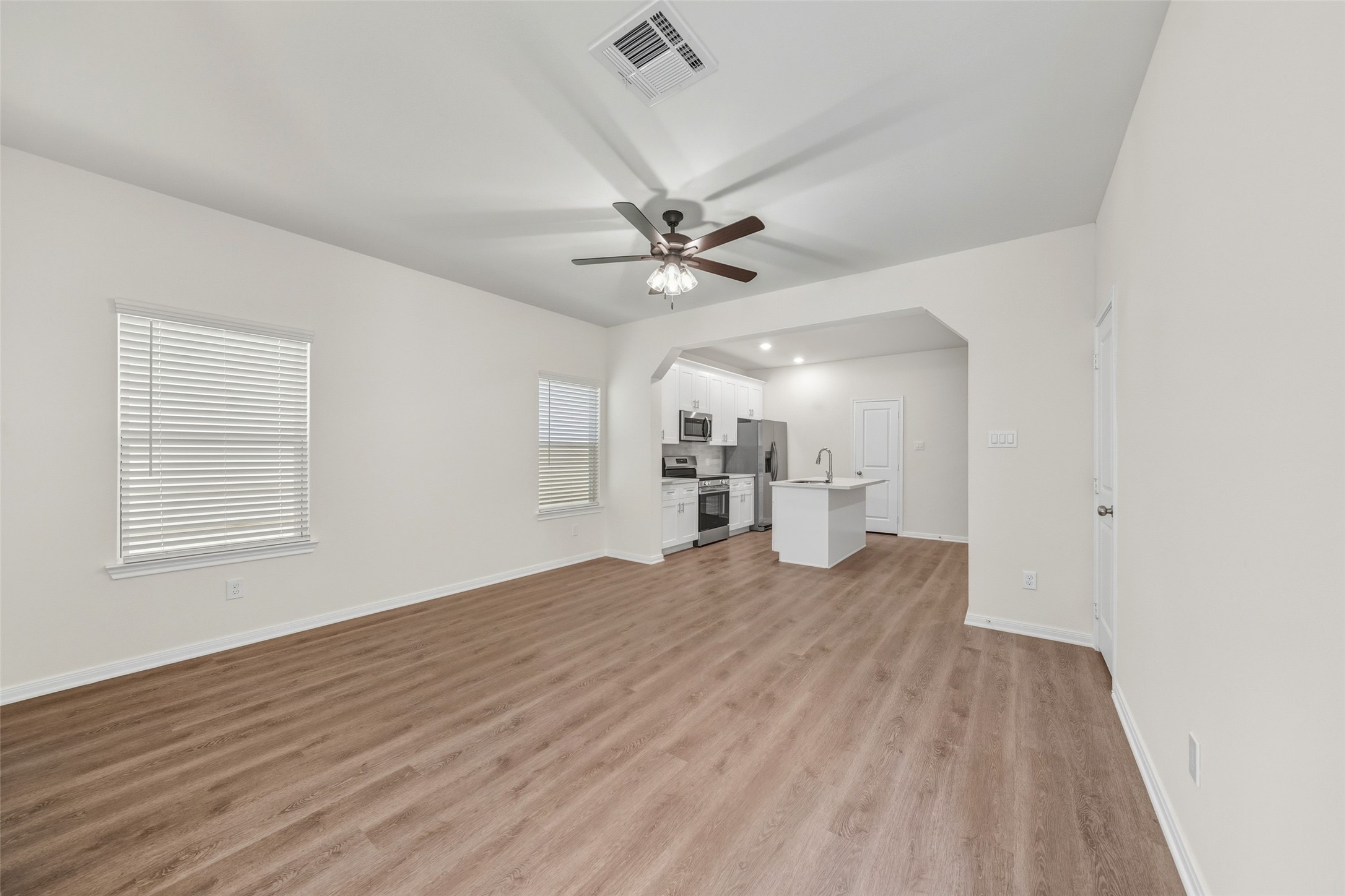 710 West Dallas Street Conroe, TX 77301 - Photo 2 of 19 wooden floor in an empty room with a window