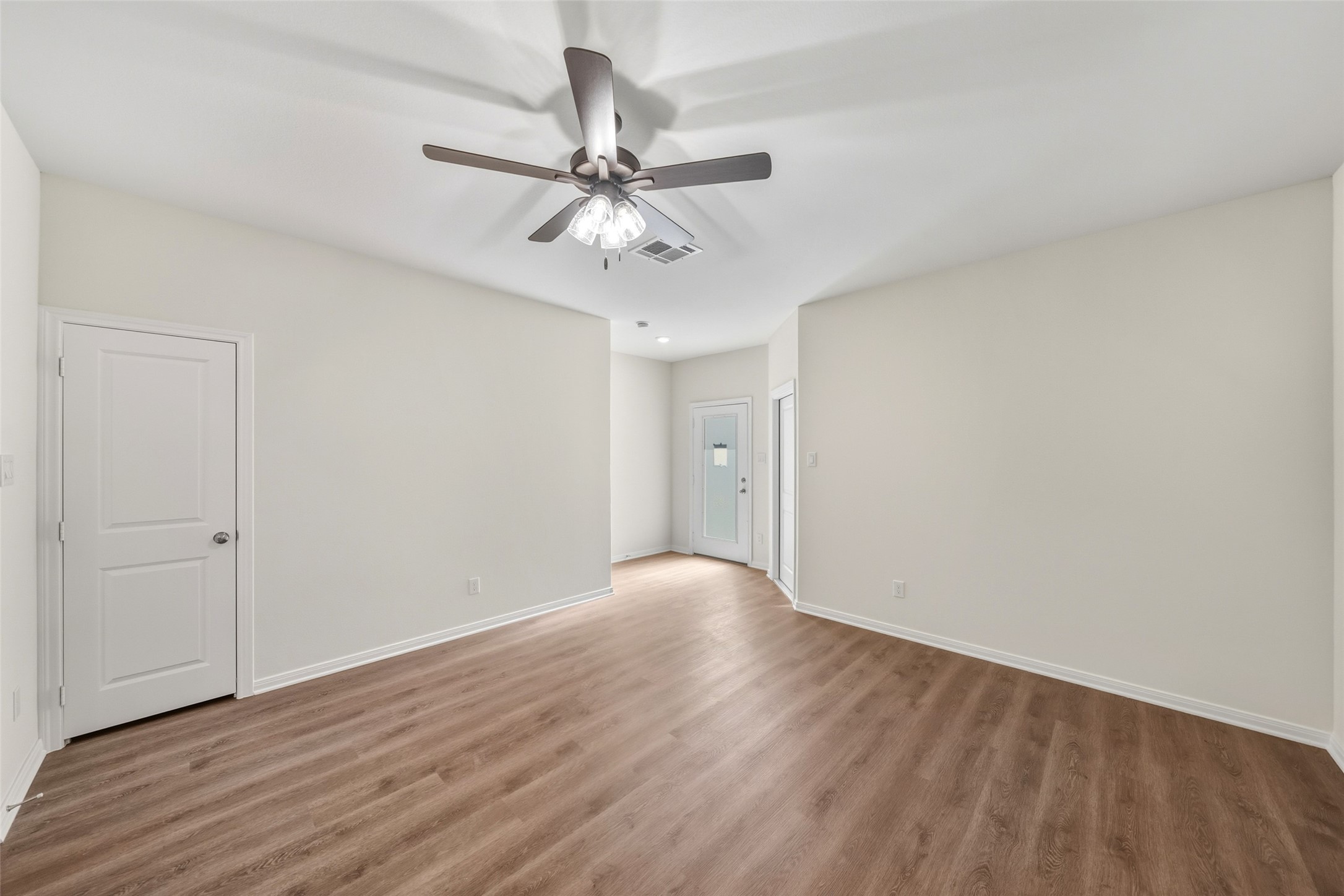710 West Dallas Street Conroe, TX 77301 - Photo 8 of 19 a view of an empty room with wooden floor