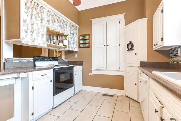a kitchen with stainless steel appliances a stove microwave and cabinets