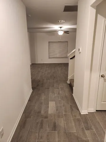 a view of a room with wooden floor