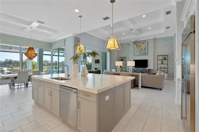 a large kitchen with kitchen island a large counter top space a sink stainless steel appliances and cabinets