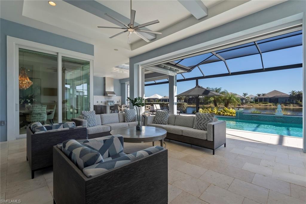 6250 Lightbourn Way Naples, FL 34113 - Photo 15 of 40 a living room with furniture and a floor to ceiling window