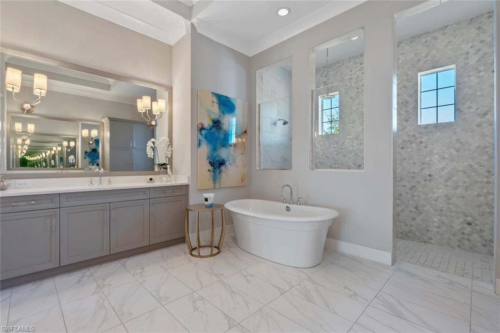 6250 Lightbourn Way Naples, FL 34113 - Photo 22 of 40 a spacious bathroom with a double vanity sink mirror and bathtub