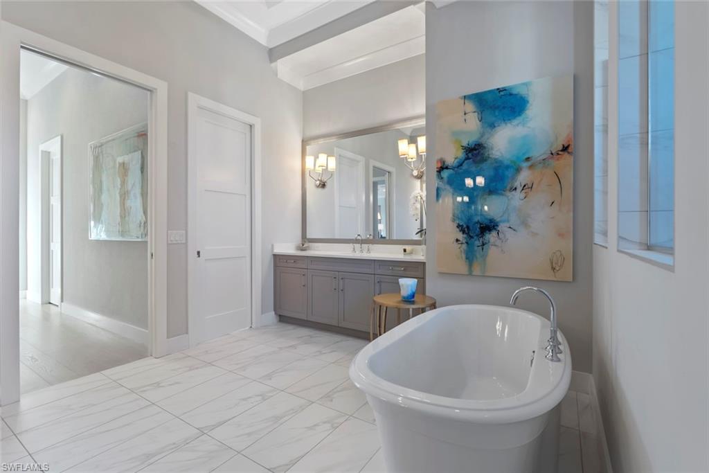 6250 Lightbourn Way Naples, FL 34113 - Photo 23 of 40 a bathroom with a sink and a mirror