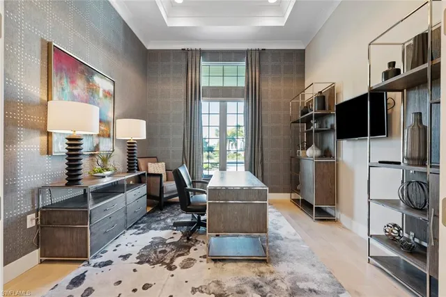 a living room with furniture a flat screen tv and a refrigerator