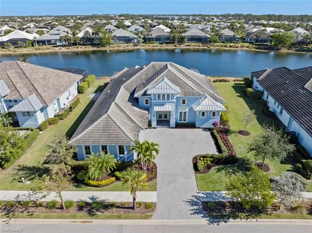 an aerial view of a house with a lake view