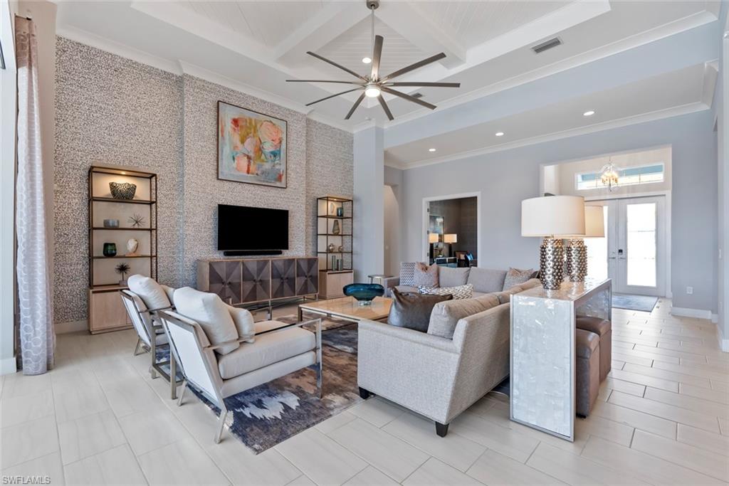 6250 Lightbourn Way Naples, FL 34113 - Photo 4 of 40 a living room with furniture a fireplace and a flat screen tv