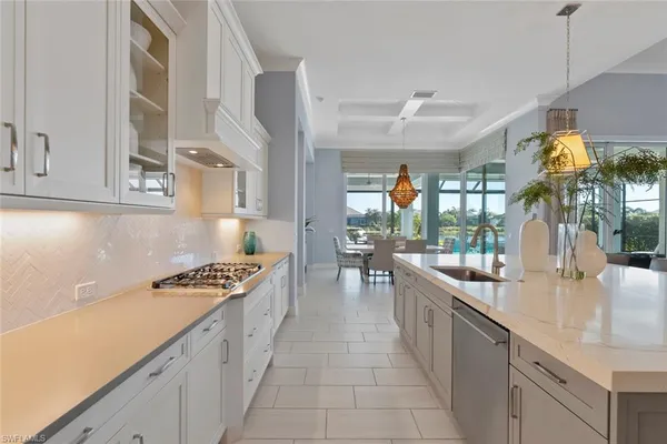 a kitchen with sink stove and cabinets