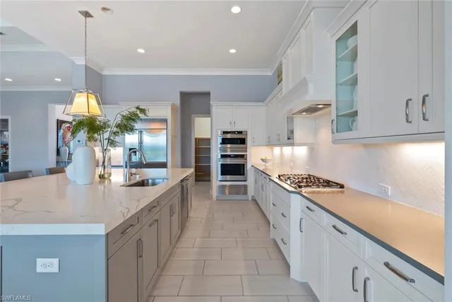 a large kitchen with stainless steel appliances granite countertop a lot of counter space and wooden floor