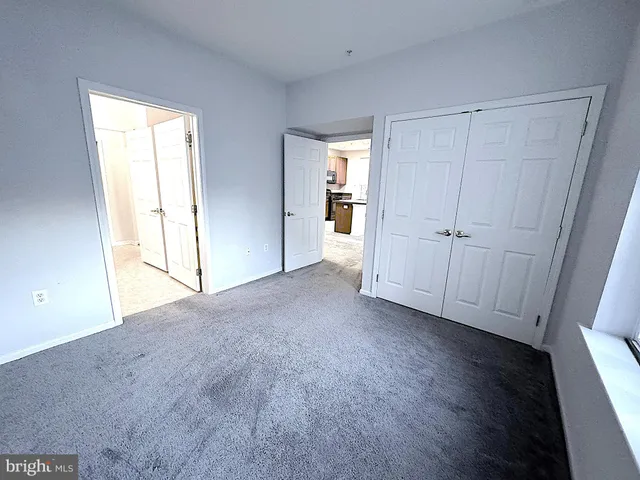 an empty room with windows and closet