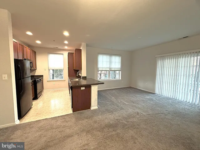 a view of a kitchen with a refrigerator and a sink