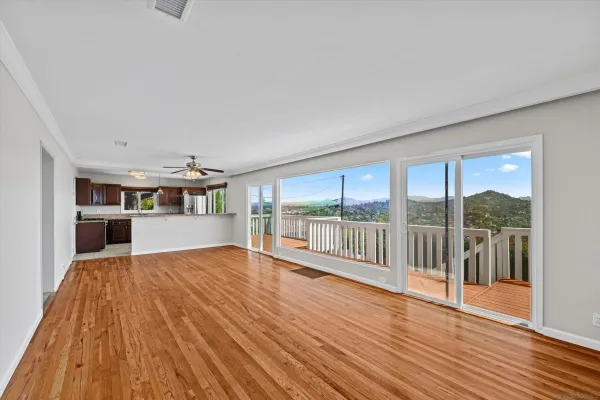 a view of a room with wooden floor