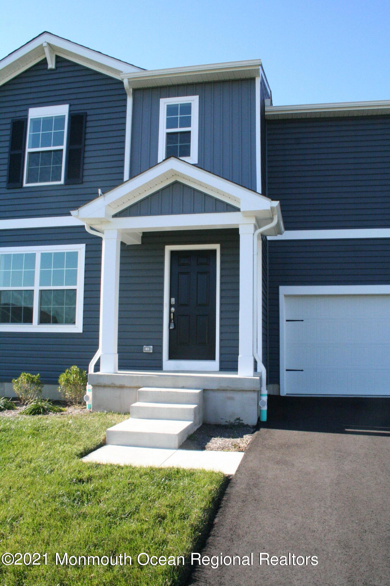 107 Cox Road Barnegat, NJ 08005 - Photo 3 of 44 a front view of a house with a yard and garage