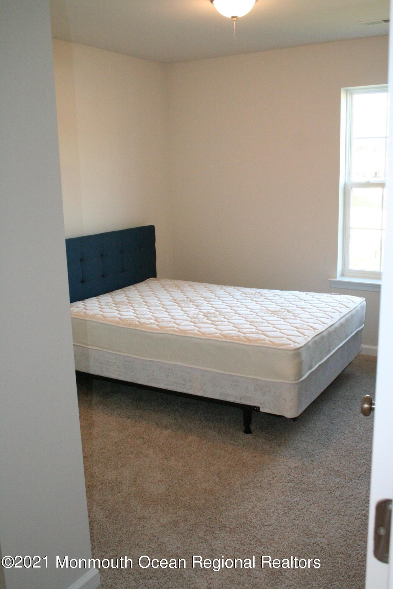 107 Cox Road Barnegat, NJ 08005 - Photo 26 of 44 a bed sitting in a bedroom next to a window