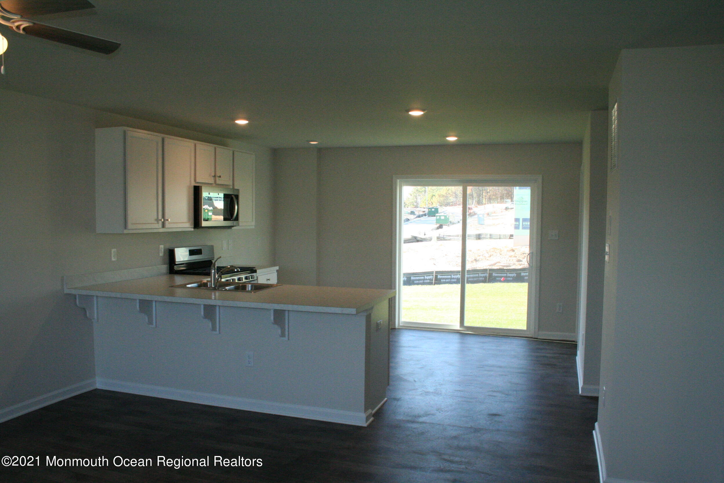 107 Cox Road Barnegat, NJ 08005 - Photo 6 of 44 a kitchen with kitchen island granite countertop a stove a sink a refrigerator cabinets and wooden floor