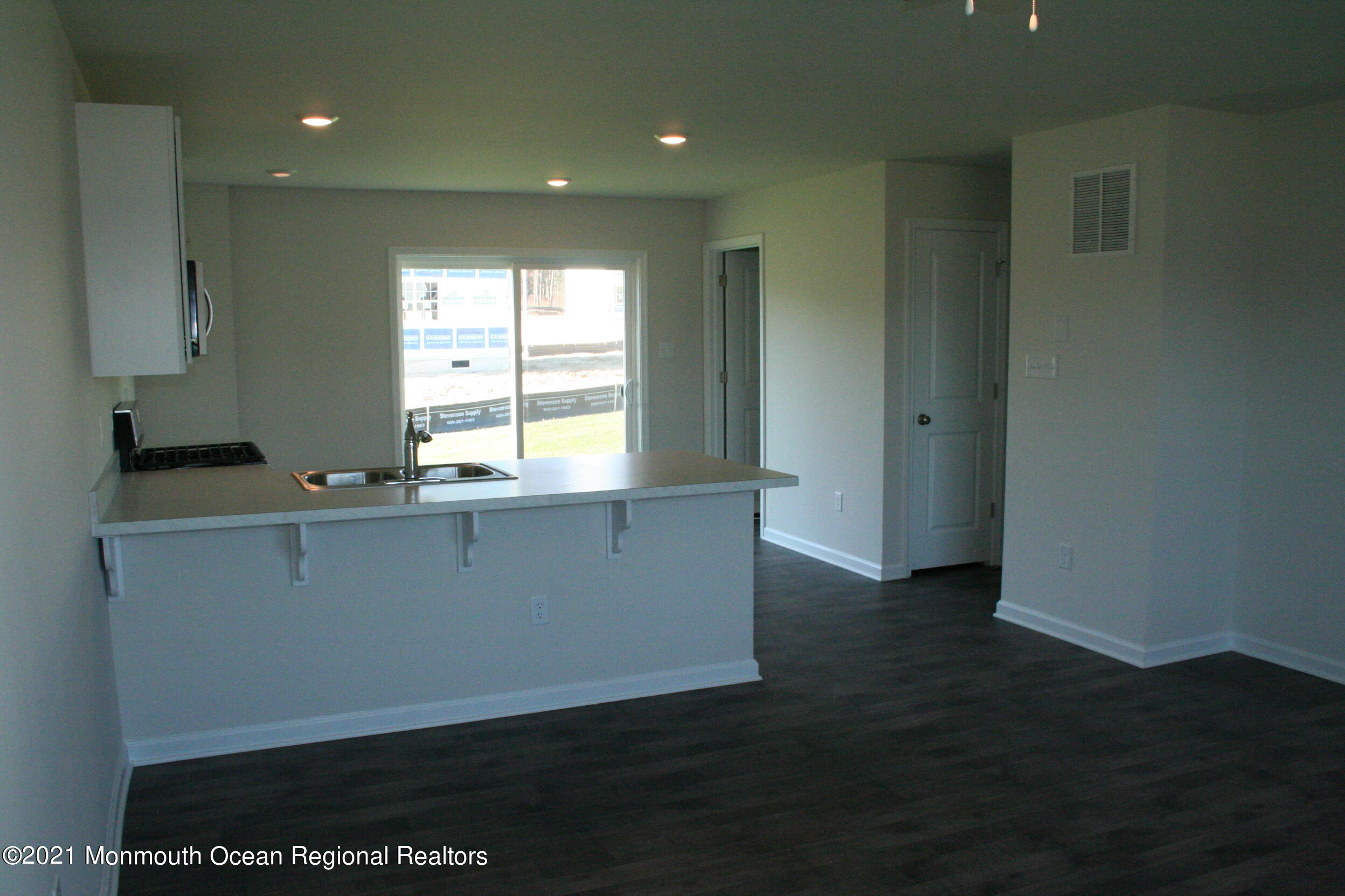107 Cox Road Barnegat, NJ 08005 - Photo 7 of 44 a view of kitchen with wooden floor and window