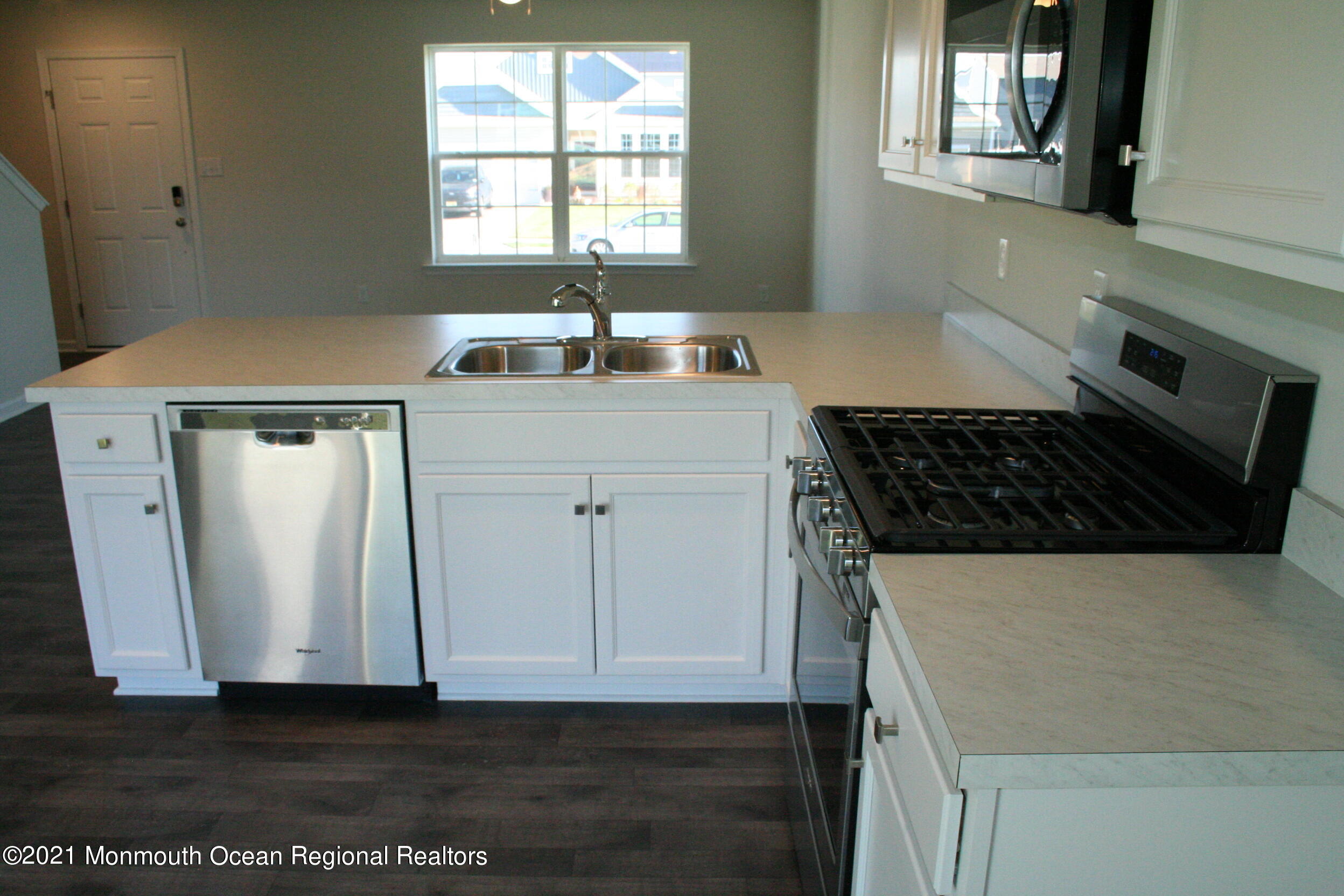 107 Cox Road Barnegat, NJ 08005 - Photo 8 of 44 a kitchen with a sink a window and cabinets