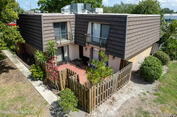 a view of a house with wooden fence