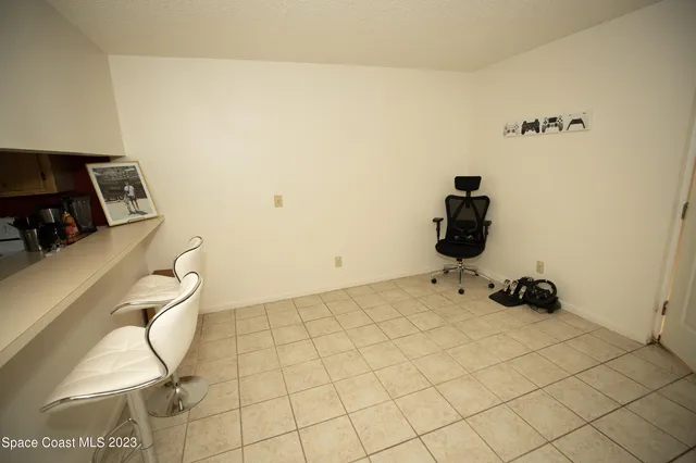 a living room with furniture a flat screen tv and a window