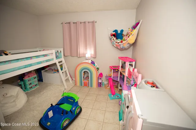 a bedroom with a bed and a television