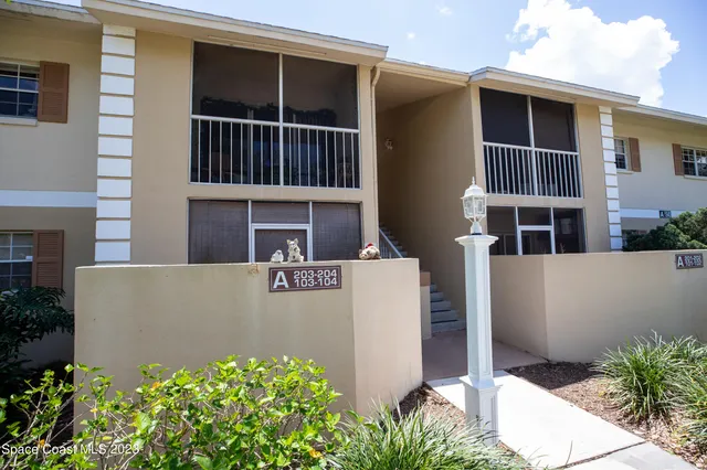 a view of a room with furniture and wooden floor
