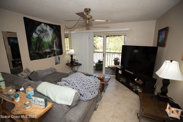 a living room with furniture and kitchen view