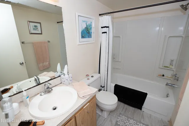 a bathroom with a sink toilet and mirror