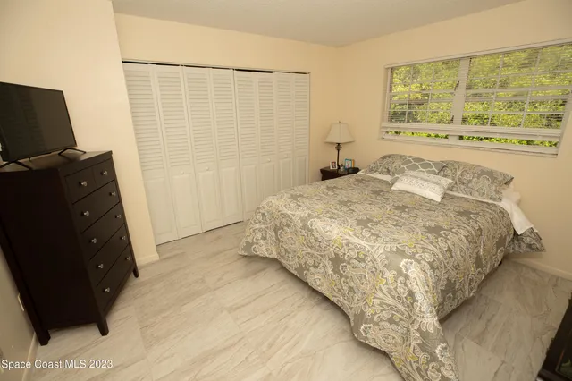 a living room with furniture a rug and a flat screen tv