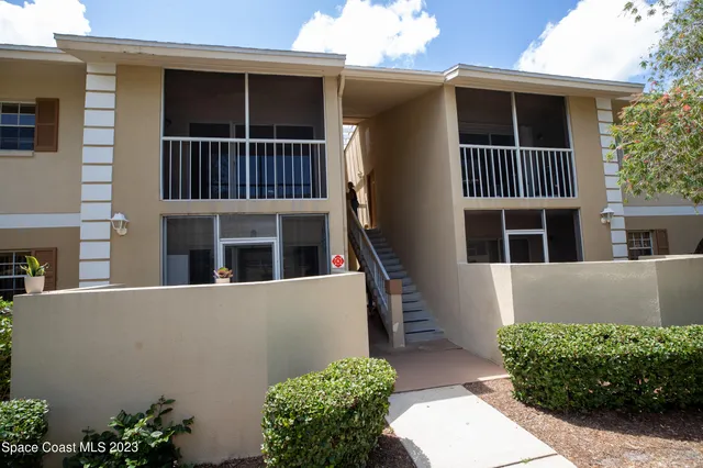 a living room with furniture a piano and a flat screen tv