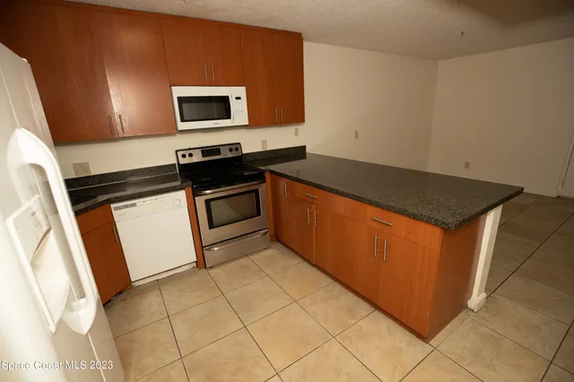 a bathroom with a sink a toilet a mirror a vanity and shower