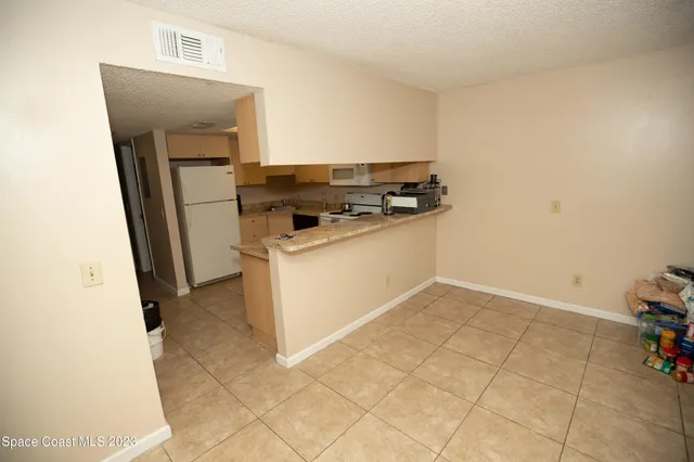 a bathroom with a granite countertop sink and a toilet