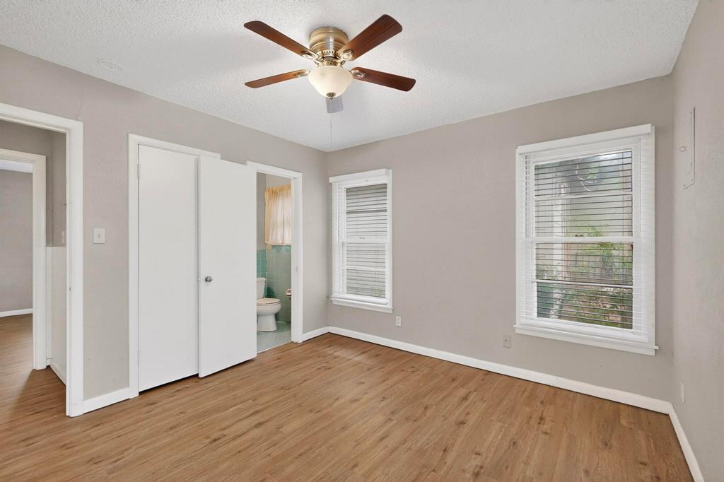 4508 Rutland Avenue Fort Worth, TX 76133 - Photo 29 of 36 a view of an empty room with wooden floor and a window
