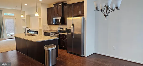 a kitchen with a refrigerator sink and stove