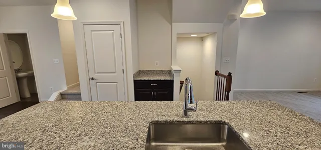 a kitchen with stainless steel appliances granite countertop a sink and a granite counter tops