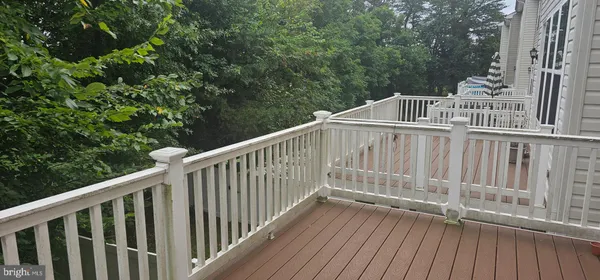 a view of deck with white fence and wooden floor