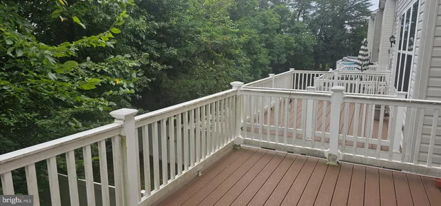 a view of deck with white fence and wooden floor