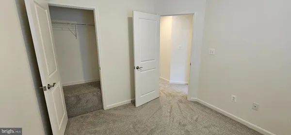 a bathroom with a granite countertop bathtub shower sink vanity and toilet