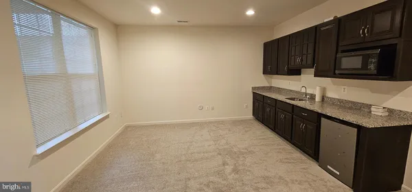 a kitchen with granite countertop a sink and a stove top oven