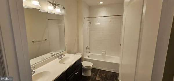a bathroom with a double vanity sink toilet and shower