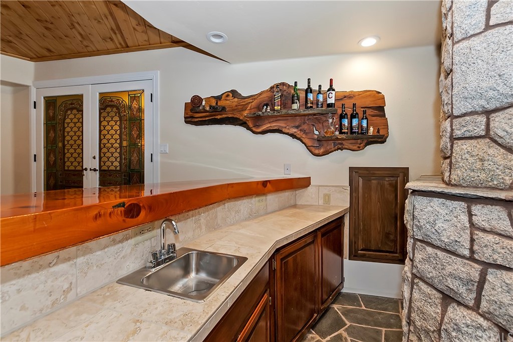 27880 Peninsula Drive North Lake Arrowhead, CA 92352 - Photo 51 of 69 a kitchen with stainless steel appliances granite countertop a sink and a microwave